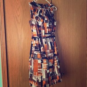 A black, white, and orange formal cocktail dress